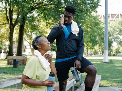 Glass of water and a black towel on bench